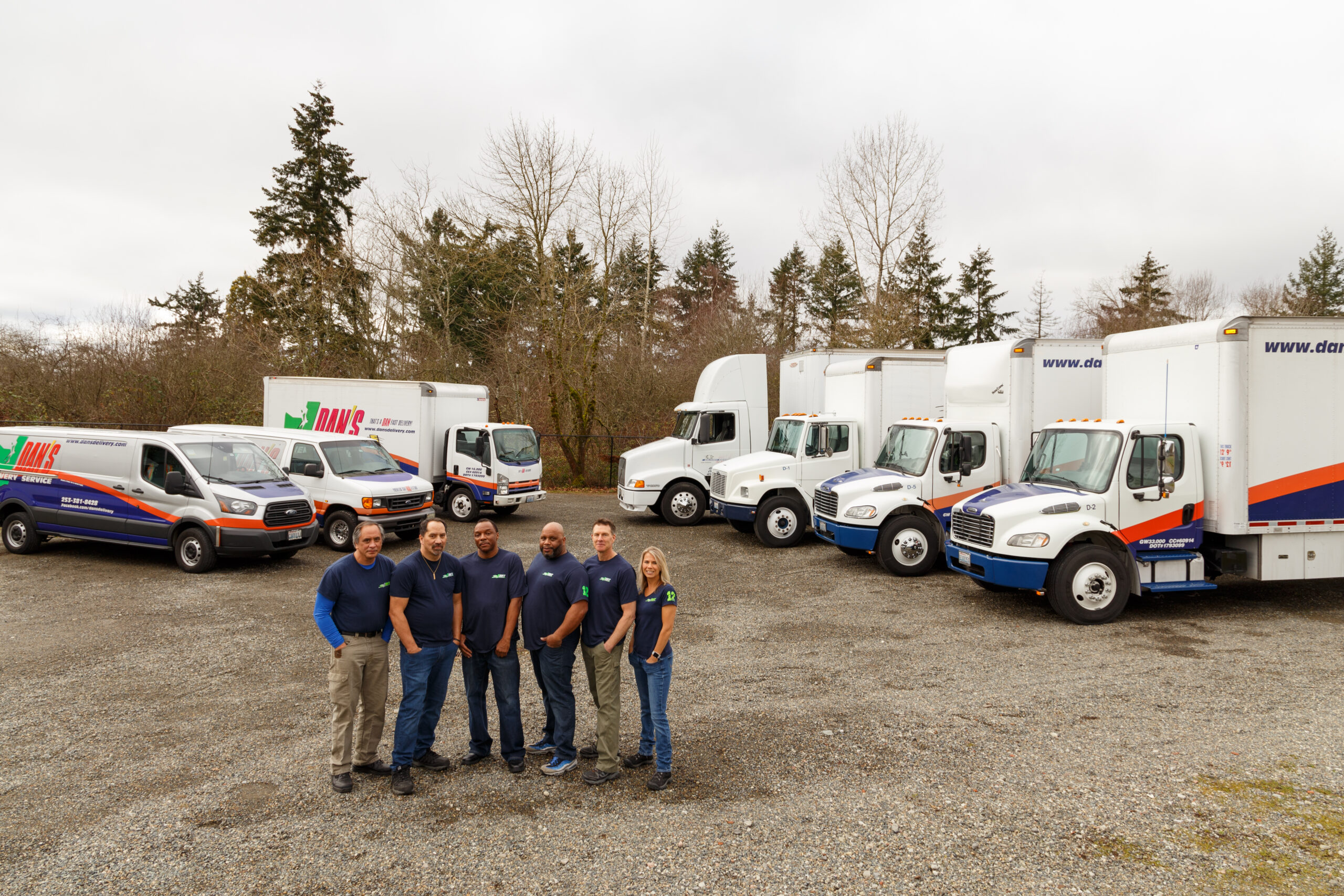 Heat Wave Hazards in Summer Freight Transport & Shipping Dan's delivery team standing outside of their fleet of trucks | summer freight transport & shipping