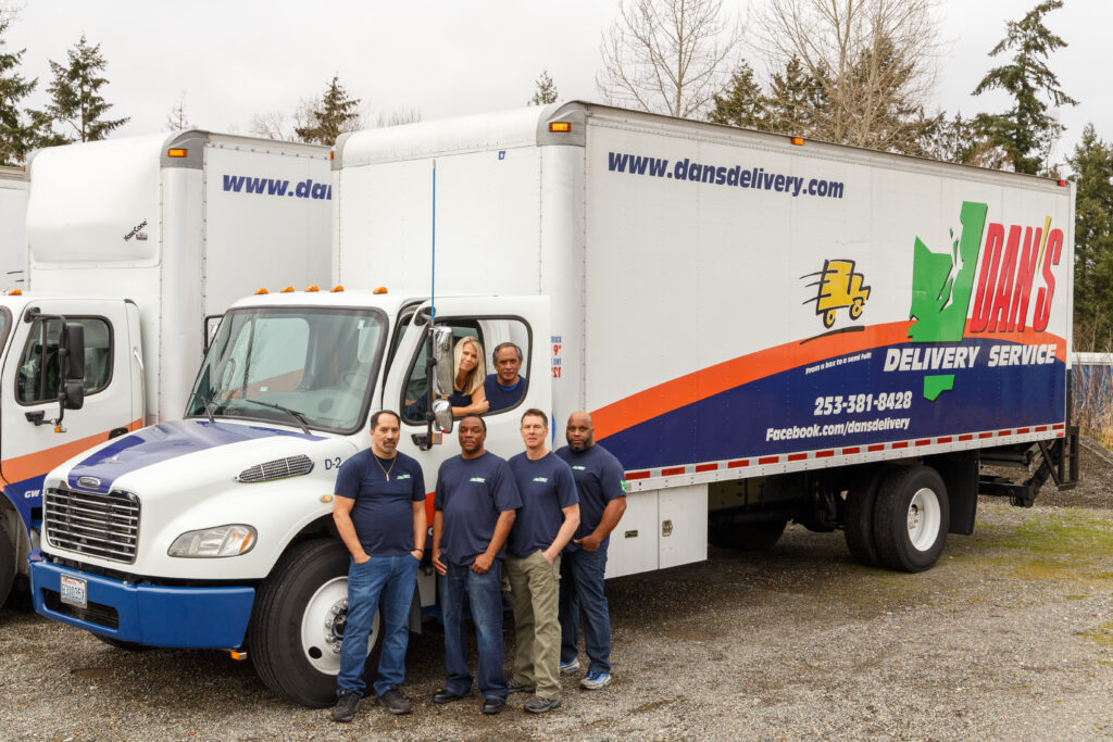 Heat Wave Hazards in Summer Freight Transport & Shipping Dan's Delivery team posing with one of their trucks